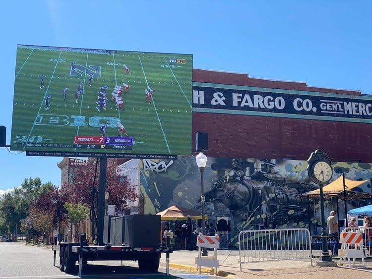 Mobile LED trailer showing a football game at a downtown watch party