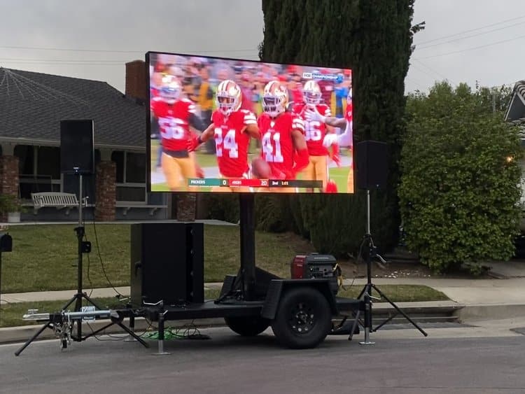 Mobile LED screen trailer with audio at a neighborhood game day event