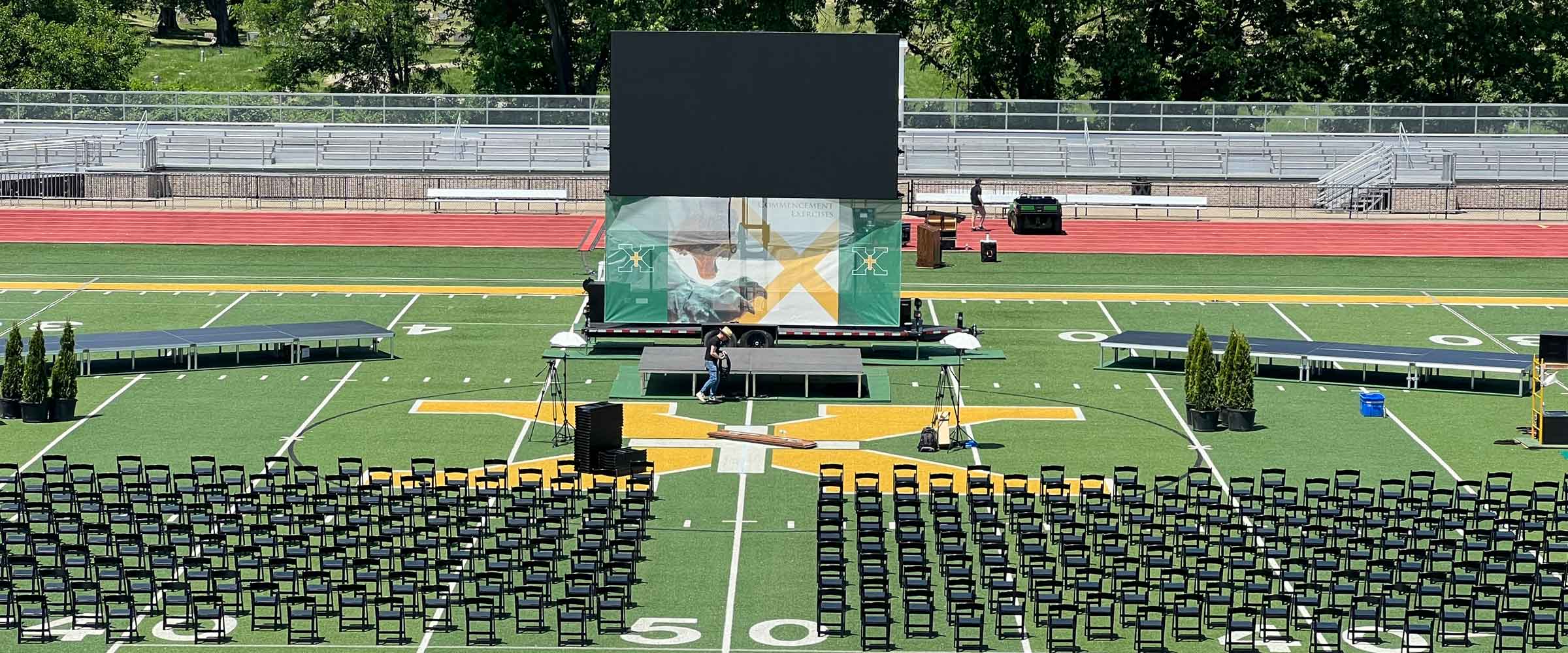 Mobile LED screen trailer on a stadium field set up for a graduation ceremony